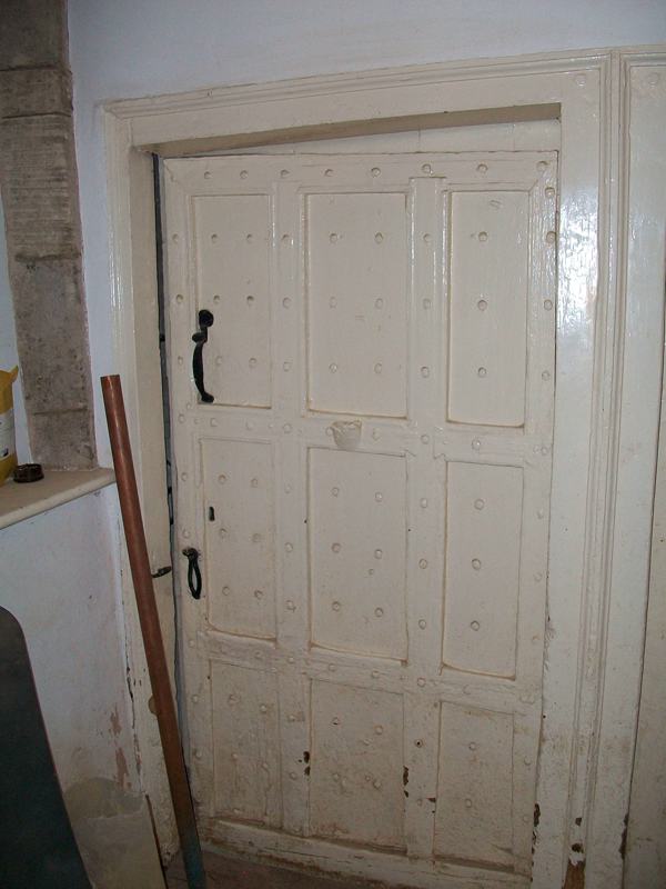 The door to the cellar. Note the candle holder still in place