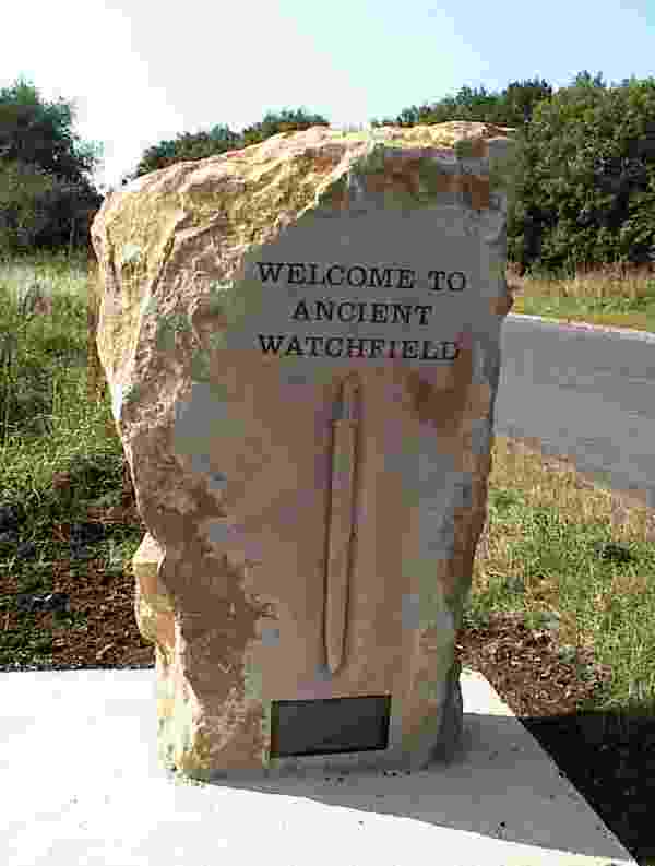 The locally quarried stone monument that announces the entrance to the village