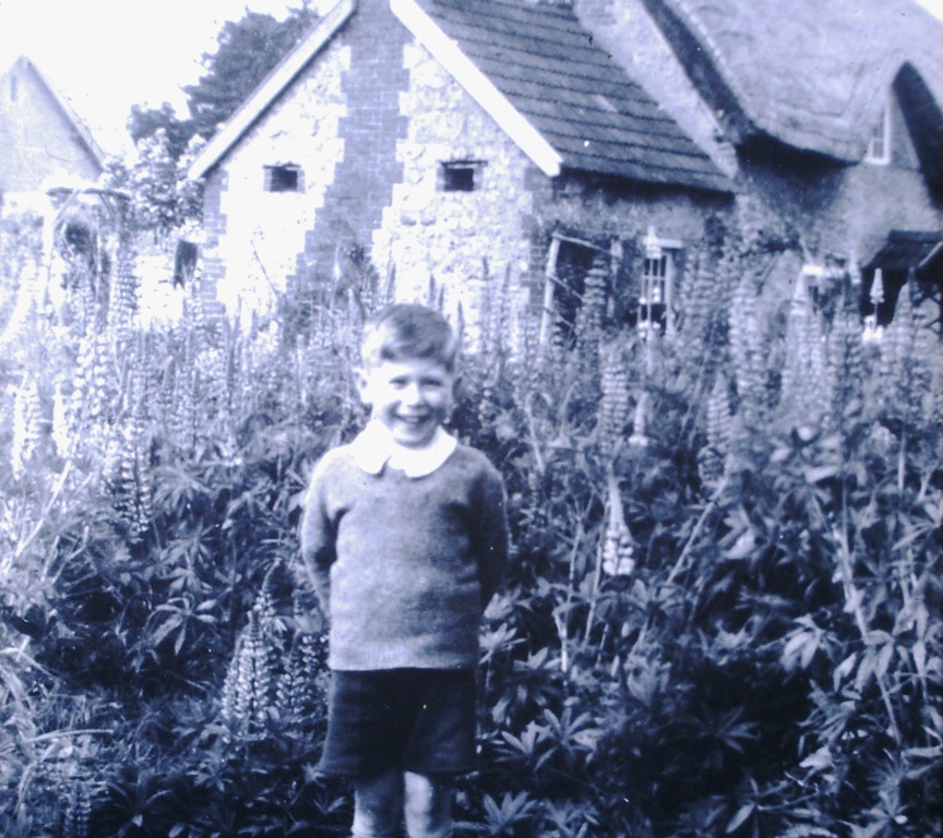 An unknown lad in the garden of a cottage in Shrivenham